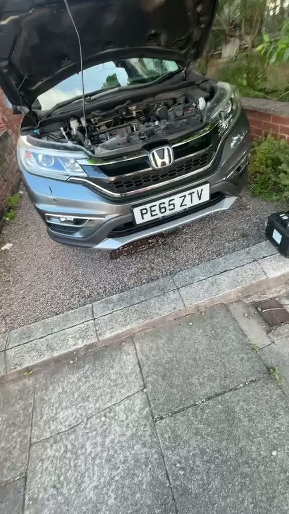Replacement car battery being fitted during a mobile call-out in Coventry