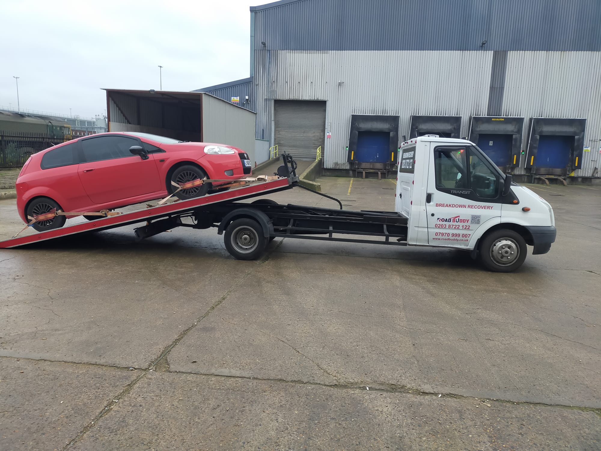 Red hatchback loaded on the Road Buddy recovery truck during a breakdown recovery job in Birmingham