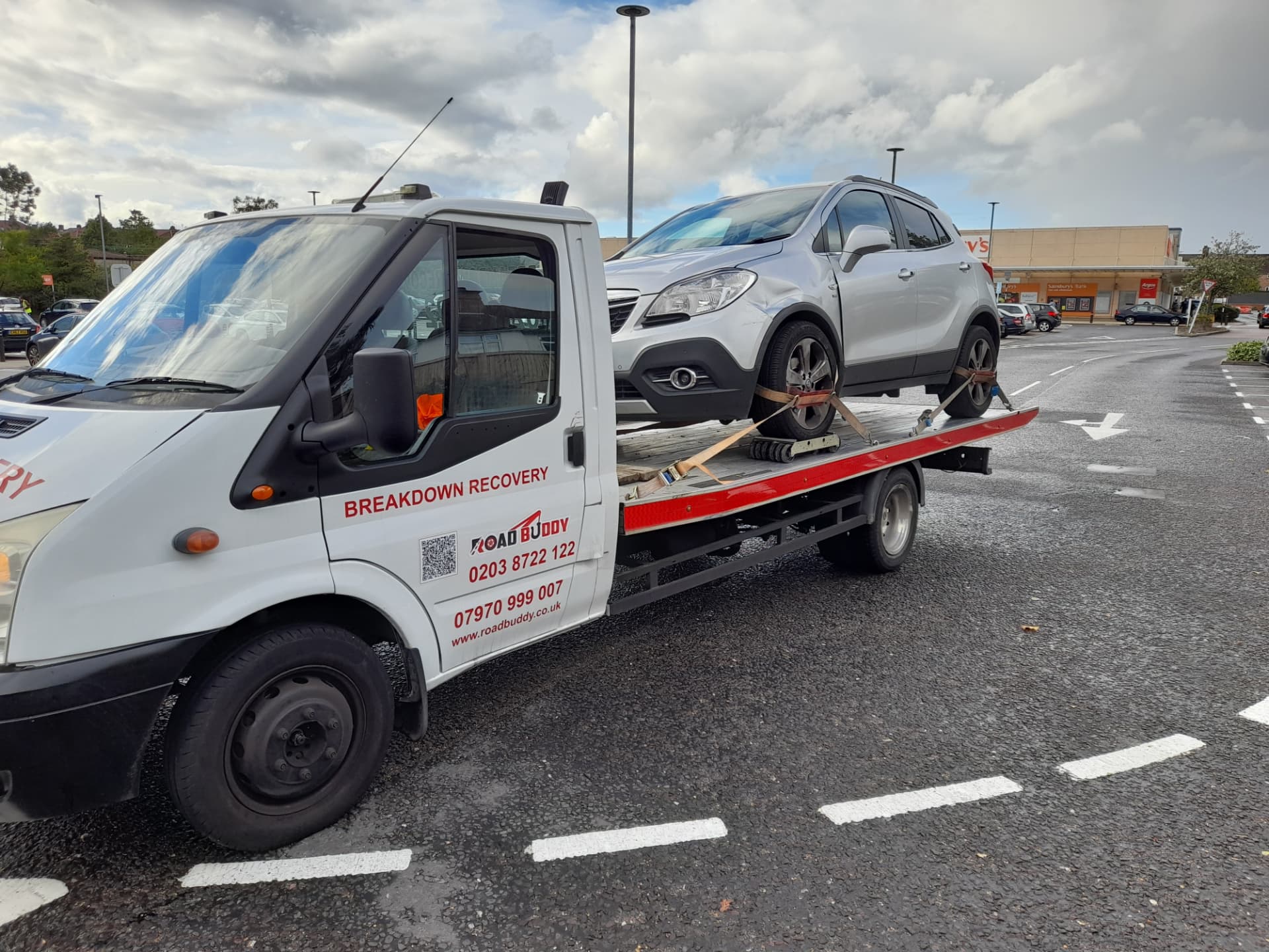 Road Buddy recovery truck carrying a silver SUV during a breakdown recovery job in Stratford-upon-Avon
